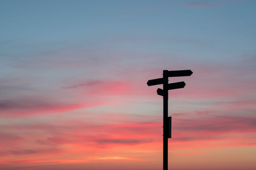Sunset sky with a signpost 